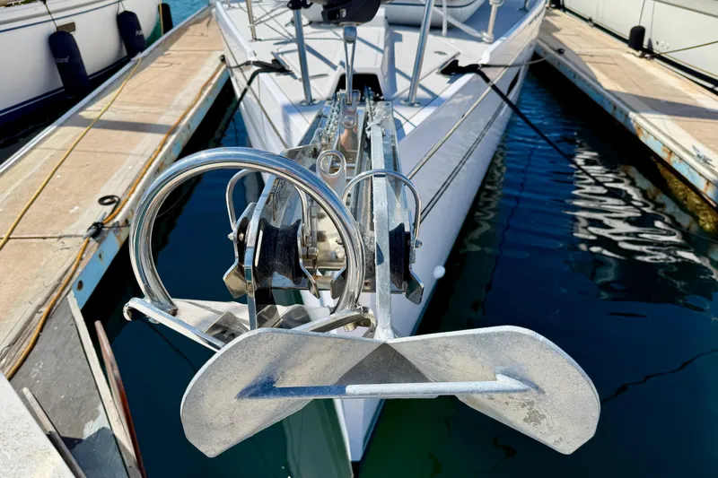 Slide: The Image of Bow view of a 2020 Catalina 425 sailboat docked, featuring anchor and deck details. - 24