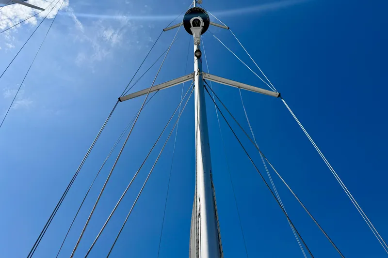 Slide: The Image of Tall mast of 2020 Catalina 425 sailboat against clear blue sky. - 26