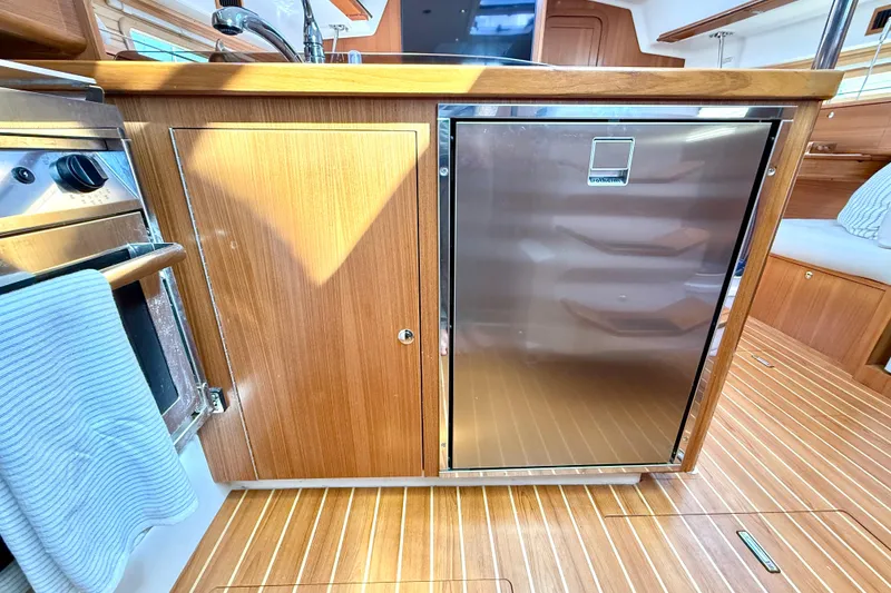 Slide: The Image of Modern kitchen area in 2020 Catalina 425 yacht with wood cabinetry and stainless steel appliances. - 33