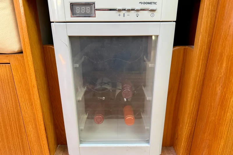 Slide: The Image of Wine cooler in a 2020 Catalina 425 yacht interior, featuring wooden cabinetry. - 34