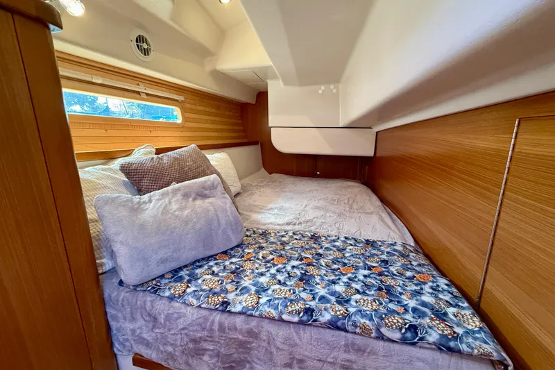 Slide: The Image of Cozy cabin interior of 2020 Catalina 425 yacht with comfortable bedding and wooden accents. - 48