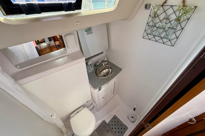 Slide: The Image of Compact bathroom in 2020 Catalina 425 yacht with sink, toilet, and decorative wall art. - 49