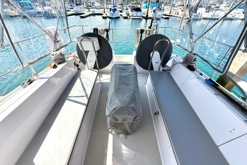 Slide: The Image of 2020 Catalina 425 yacht cockpit with seating, covered equipment, and marina view. - 5