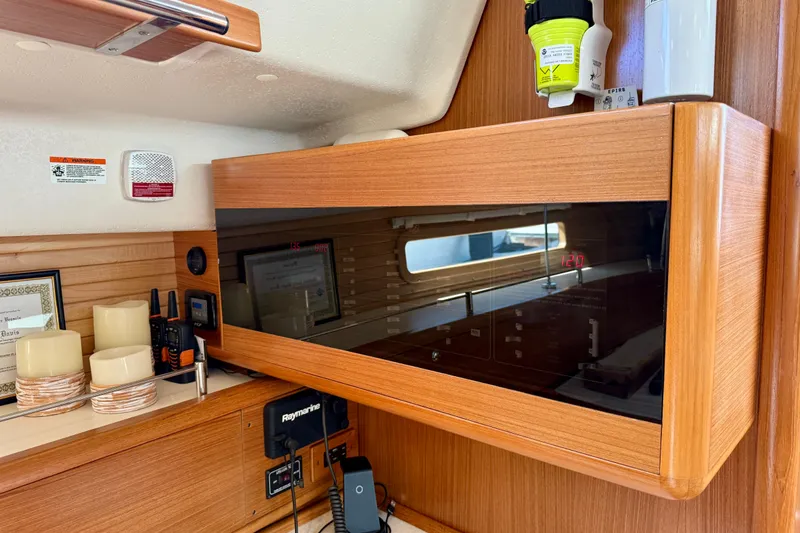 Slide: The Image of Interior of a 2020 Catalina 425 yacht featuring wooden cabinetry and modern navigation equipment. - 56