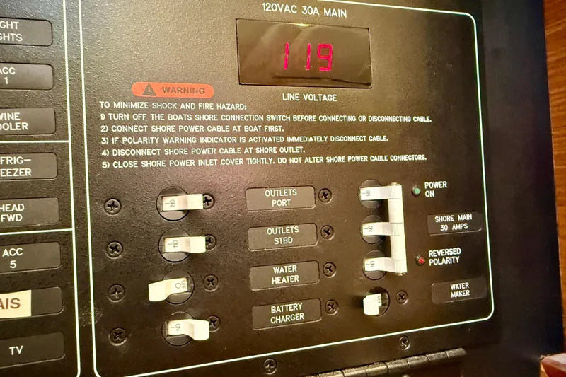 Slide: The Image of Electrical panel of a 2020 Catalina 425 boat showing voltage and safety instructions. - 60