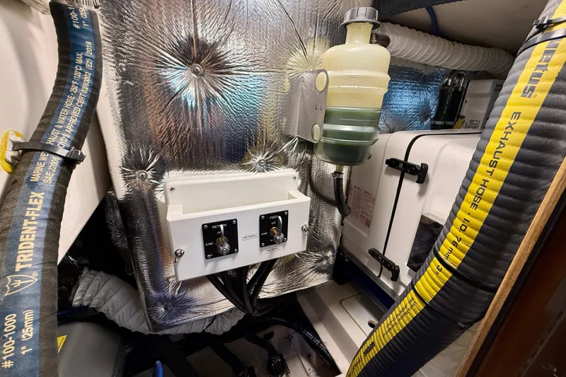 Slide: The Image of Engine compartment of 2020 Catalina 425 sailboat with hoses and control panel. - 68