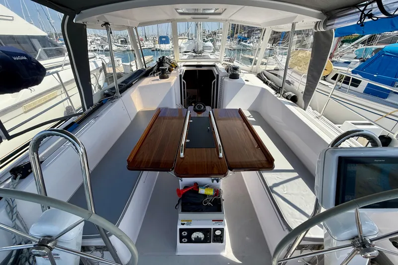 Slide: The Image of Cockpit of 2020 Catalina 425 sailboat with dual steering wheels and wooden table. - 7