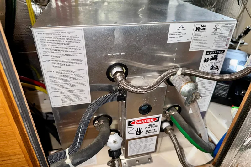 Slide: The Image of Electrical system with warning labels in a 2020 Catalina 425 boat. - 71