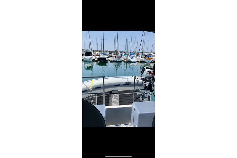 Slide: The Image of Marina view from 2020 Catalina 425 sailboat, featuring docked boats and clear blue water. - 80