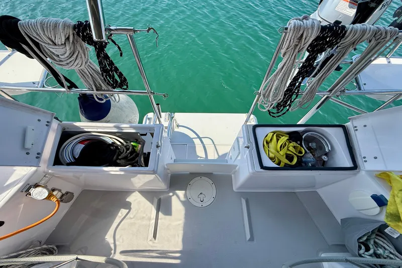 Slide: The Image of 2020 Catalina 425 sailboat deck with storage compartments and coiled ropes. - 9