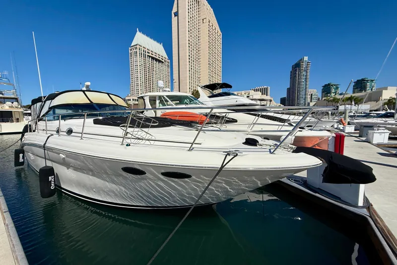 The Image of 2003 Sea Ray 380 Sundancer yacht docked in urban marina with city skyline. - 0