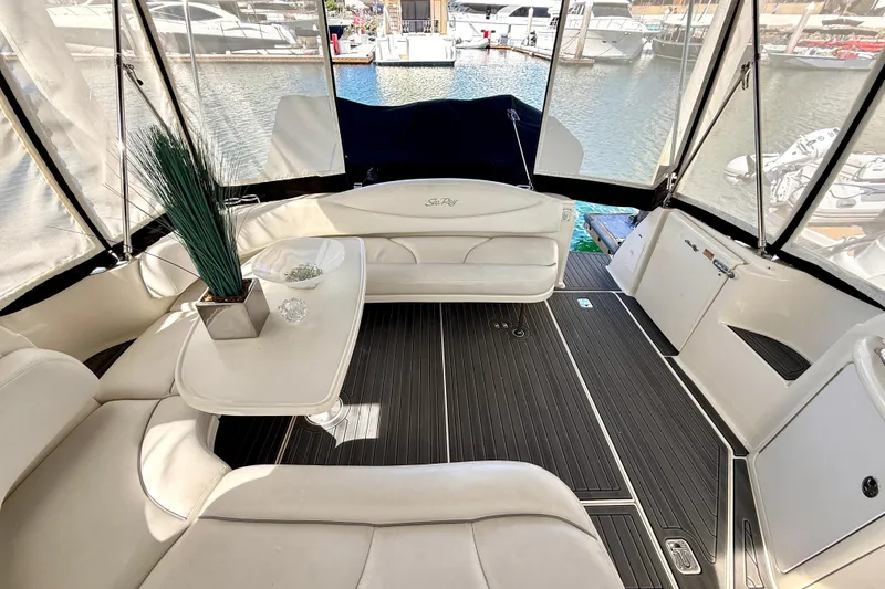 Slide: The Image of Interior of 2003 Sea Ray 380 Sundancer yacht with elegant seating and table setup. - 11