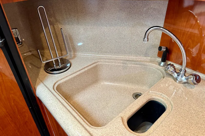 Slide: The Image of Kitchen sink area on a 2003 Sea Ray 380 Sundancer yacht. - 21