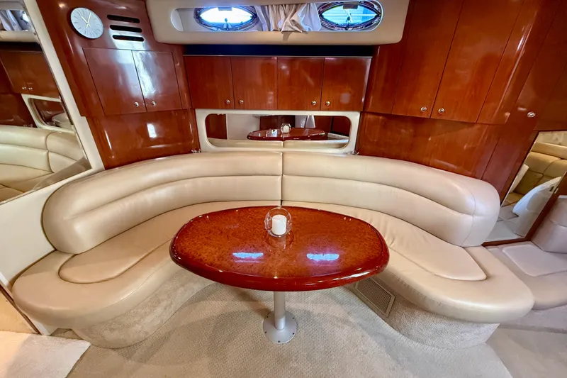 Slide: The Image of Luxurious interior of 2003 Sea Ray 380 Sundancer with leather seating and wooden table. - 24
