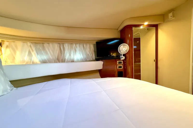 Slide: The Image of Luxurious cabin interior of 2003 Sea Ray 380 Sundancer yacht with bed and TV. - 28