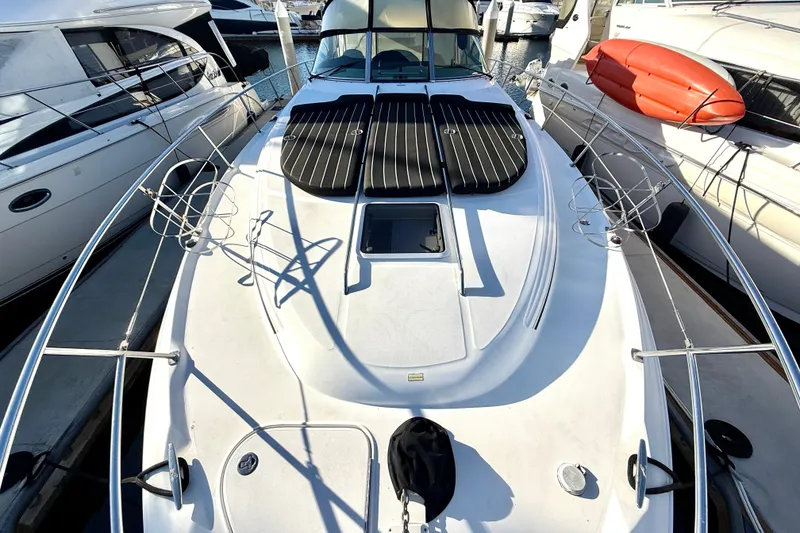 Slide: The Image of 2003 Sea Ray 380 Sundancer yacht docked at marina, featuring spacious deck and sleek design. - 3
