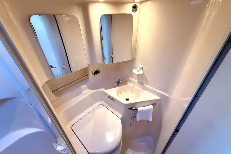 Slide: The Image of Compact bathroom in 2003 Sea Ray 380 Sundancer yacht with sink, mirror, and toilet. - 30