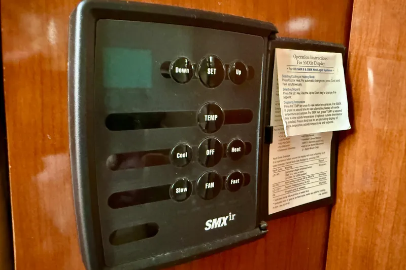 Slide: The Image of Control panel on a 2003 Sea Ray 380 Sundancer yacht, featuring temperature and fan settings. - 31