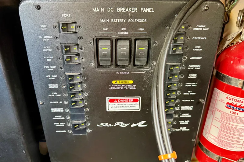 Slide: The Image of Main DC breaker panel of 2003 Sea Ray 380 Sundancer with fire extinguisher. - 33