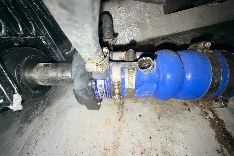 Slide: The Image of Close-up of a 2003 Sea Ray 380 Sundancer engine component with blue hose and clamps. - 39