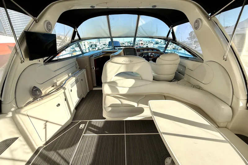 Slide: The Image of Interior of 2003 Sea Ray 380 Sundancer yacht with luxurious seating and helm. - 8