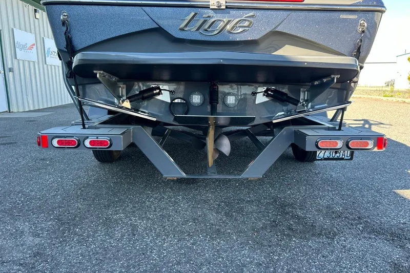 Slide: The Image of 2018 Tigé R20 boat rear view with trailer, parked on asphalt. - 10