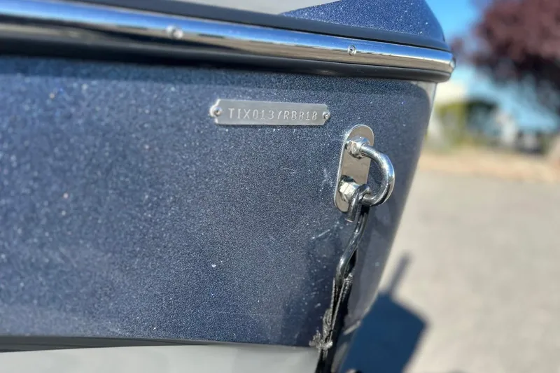 Slide: The Image of 2018 Tigé R20 boat hull with identification plate and chain attachment. - 12