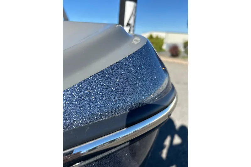 Slide: The Image of Close-up of 2018 Tigé R20 boat's metallic blue bow under clear sky. - 13