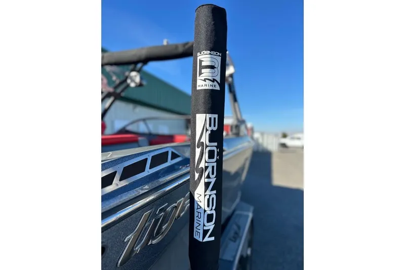 Slide: The Image of 2018 Tigé R20 boat with Bjornson Marine branding, outdoor setting, clear sky. - 15