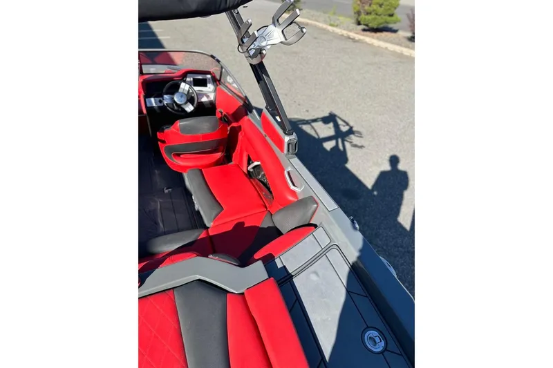 Slide: The Image of 2018 Tigé R20 boat interior with red and black seating, steering wheel visible. - 19