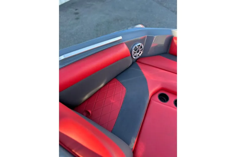 Slide: The Image of 2018 Tigé R20 boat interior with red and gray seating, speaker, and cup holders. - 25