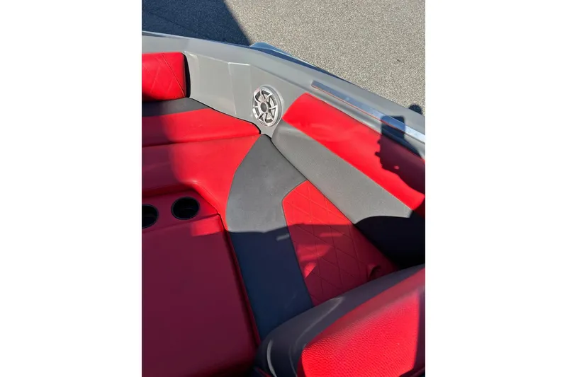 Slide: The Image of 2018 Tigé R20 boat interior with red and gray seating, featuring cup holders and speaker. - 27