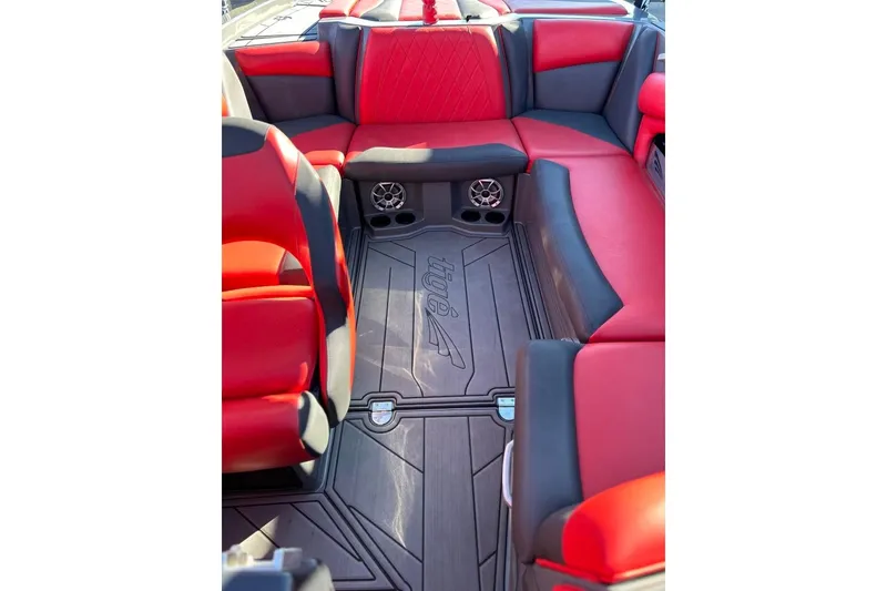 Slide: The Image of 2018 Tigé R20 boat interior with red and black seating, featuring speakers and cup holders. - 29