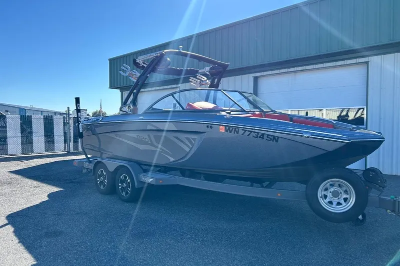 Slide: The Image of 2018 Tigé R20 boat on trailer, parked outside a warehouse. - 3