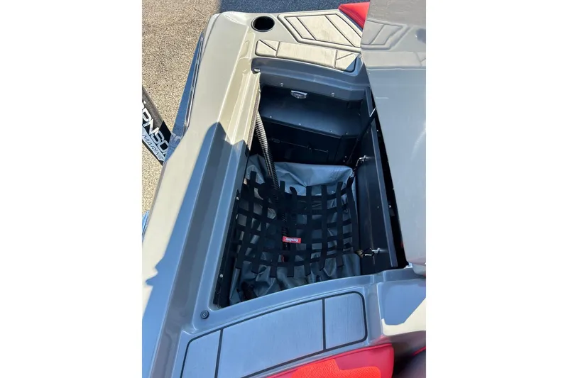 Slide: The Image of 2018 Tigé R20 boat storage compartment with netting and red interior accents. - 30