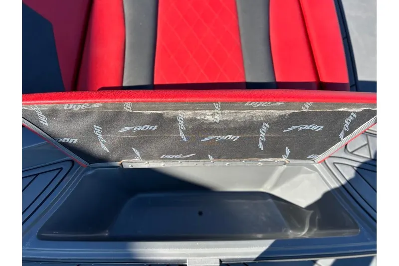 Slide: The Image of Red and black interior of 2018 Tigé R20 boat with storage compartment. - 38