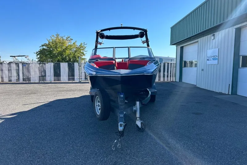 Slide: The Image of 2018 Tigé R20 boat on trailer, parked outside a marine facility. - 4