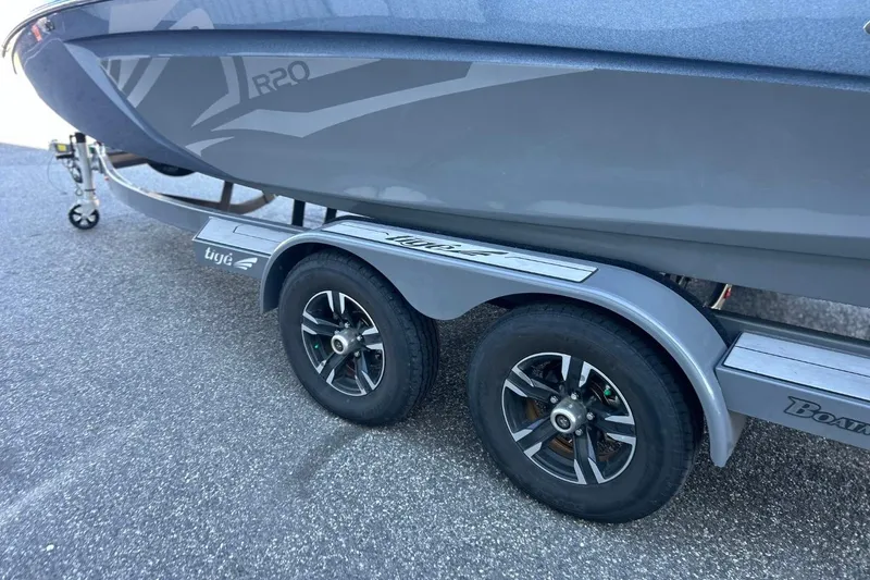 Slide: The Image of 2018 Tigé R20 boat on a dual-axle trailer, parked on asphalt. - 8