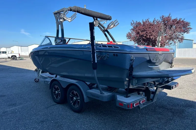 Slide: The Image of 2018 Tigé R20 boat on trailer, parked outdoors under clear blue sky. - 9