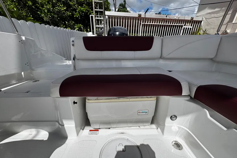 Slide: The Image of 2017 Tahoe 2150 boat interior with white and maroon seating, outdoor setting. - 14