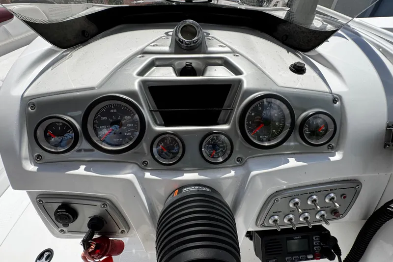 Slide: The Image of Dashboard of a 2017 Tahoe 2150 boat with gauges and controls. - 19