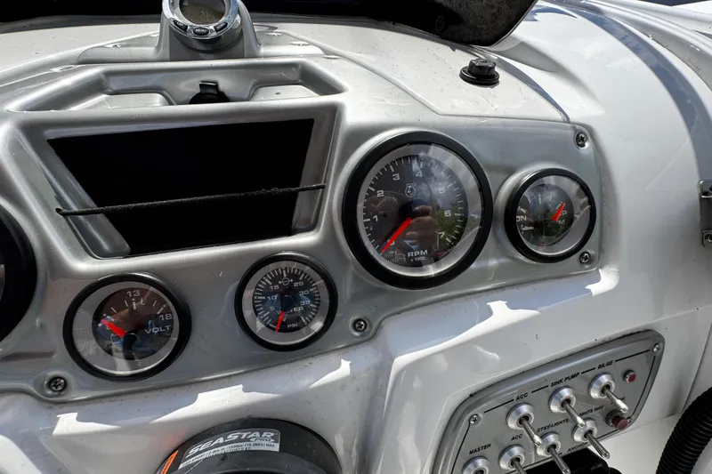 Slide: The Image of Dashboard of a 2017 Tahoe 2150 boat with gauges and switches. - 20