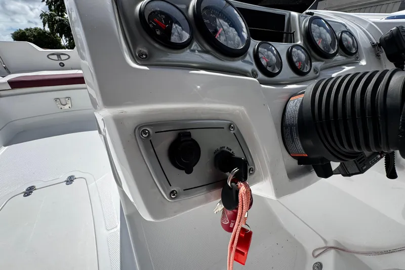 Slide: The Image of Control panel of a 2017 Tahoe 2150 boat with gauges and ignition key. - 22
