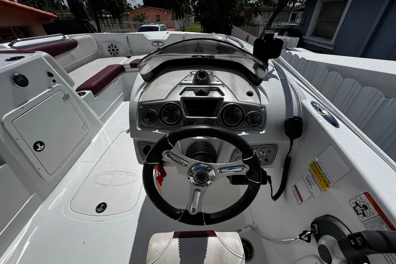 Slide: The Image of Interior view of a 2017 Tahoe 2150 boat cockpit with steering wheel and controls. - 24