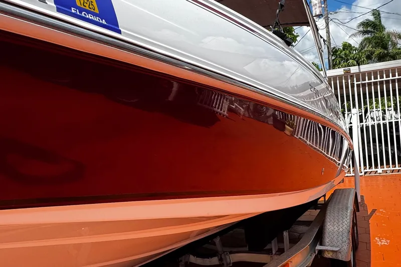 Slide: The Image of 2017 Tahoe 2150 boat on trailer, red and white exterior, Florida registration. - 3