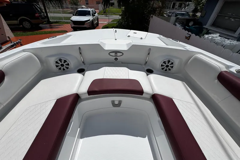 Slide: The Image of 2017 Tahoe 2150 boat interior with white and maroon seating, featuring built-in speakers. - 31