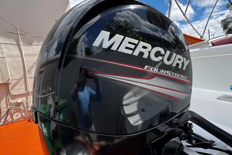 Slide: The Image of Mercury FourStroke engine on 2017 Tahoe 2150 boat, reflecting sky and surroundings. - 37