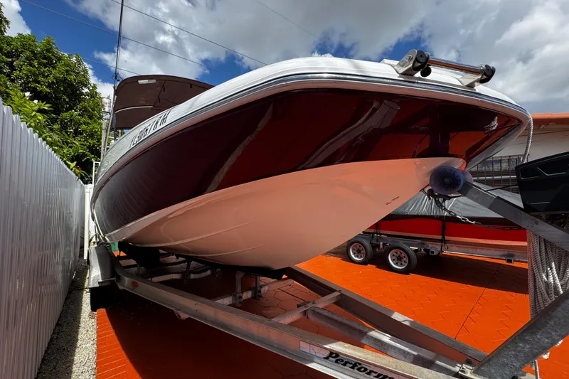 Slide: The Image of 2017 Tahoe 2150 boat on trailer, parked outdoors under a partly cloudy sky. - 41