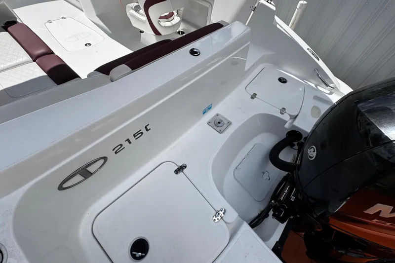 Slide: The Image of 2017 Tahoe 2150 boat interior with seating and engine details. - 9