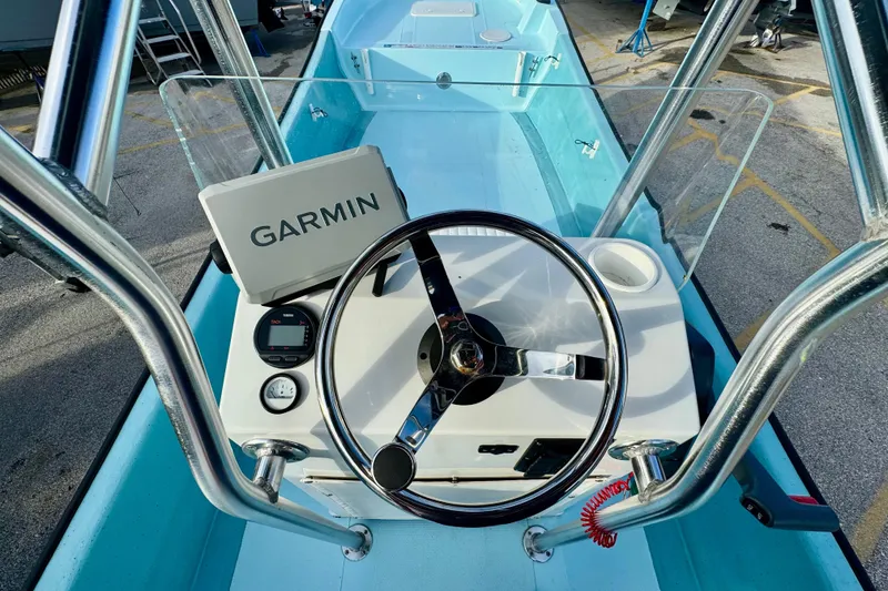 Slide: The Image of 2024 Panga 25 CC boat dashboard with Garmin navigation system and steering wheel. - 11
